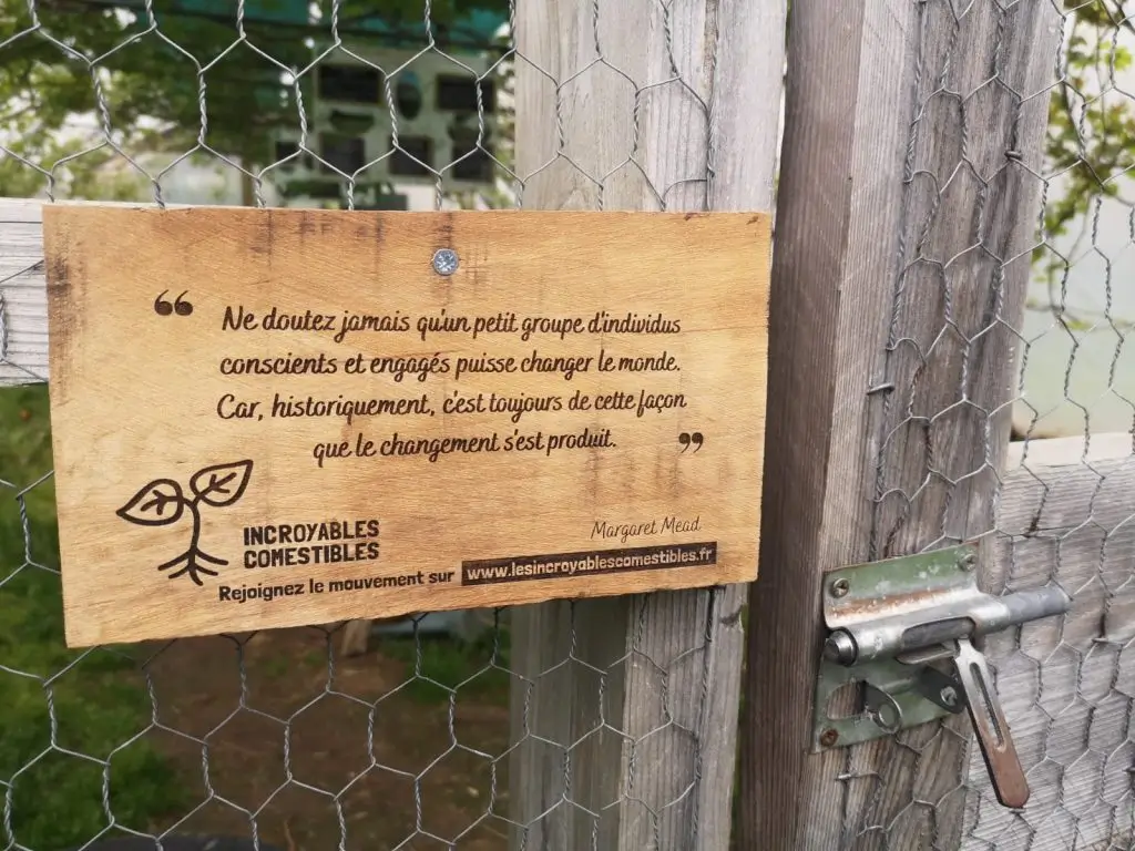 Panneau en bois à l'entrée d'un jardin partagé des Incroyables Comestibles, invitation à l'action